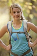 USA, Utah, young woman with backpack in forest. Photo : Mike Kemp