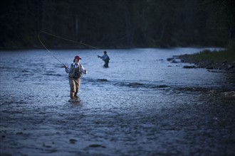 Canada, British Columbia, Fernie, Women fly fishing in river. Photo : Dan Bannister
