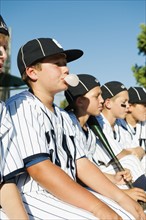 USA, California, Ladera Ranch, Boys (10-11) from little league sitting on dugout.