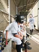 USA, California, Ladera Ranch, Boys (10-11) from little league sitting on dugout.