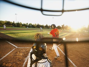 USA, California, Ladera Ranch, boys (10-11) playing baseball seen through helmet.