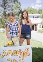 USA, New York, Two girls (10-11, 10-11) selling lemonade. Photo : Jamie Grill Photography