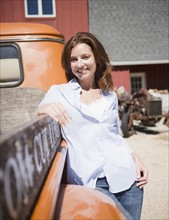 USA, New York, Flanders, Portrait of woman leaning at truck. Photo : Jamie Grill Photography
