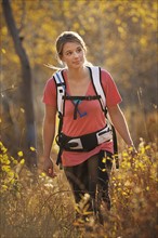 USA, Utah, young woman hiking in forest. Photo : Mike Kemp