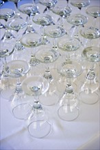 Rows of wine glasses on table .
