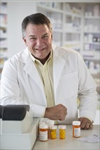 USA, New Jersey, Jersey City, Portrait of pharmacist selling medication in pharmacy.