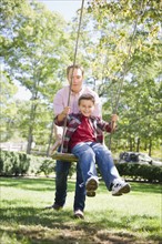 USA, New York, Flanders, Father and son (8-9) playing in garden. Photo : Jamie Grill Photography