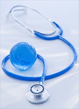 Close-up view of blue globe with stethoscope. Photo : Daniel Grill