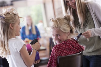 USA, Utah, family portrait of sisters (6-7, 8-9, 12-13, 14-15, 16-17) preparing hairs and having