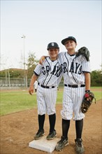 USA, California, Ladera Ranch, two boys (10-11) in baseball uniforms.