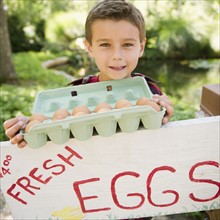 USA, New York, Flanders, Mother and son (8-9) selling fresh eggs. Photo : Jamie Grill Photography