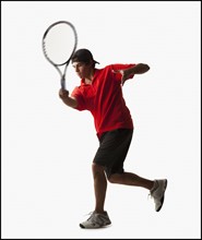 Young man playing tennis. Photo : Mike Kemp