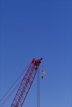 USA, New York, New York City, Construction crane with American flag.