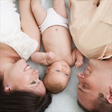USA, New Jersey, Jersey City, Family with baby daughter (2-5 months) laying upside down. Photo :