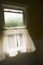 Wind blowing curtains through window.