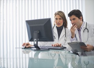 USA, New Jersey, Jersey City, Two doctors using computer in office.