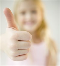 USA, New Jersey, Jersey City, Girl (8-9) with thumb-up. Photo : Jamie Grill Photography