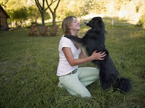 USA, Colorado, Young happy woman with her dog. Photo : John Kelly