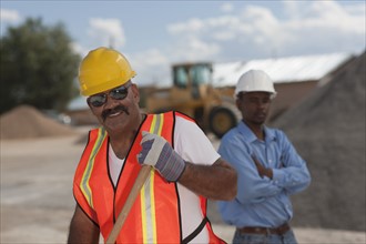 Portrait of construction workers on building site. Photo : Dan Bannister