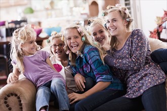 USA, Utah, family portrait of sisters (6-7, 8-9, 12-13, 14-15, 16-17) on sofa having fun. Photo :
