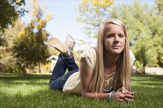 USA, Utah, outdoor of blonde girl (12-13) lying on grass. Photo : Tim Pannell