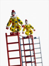 Studio shot of figurines on ladders. Photo : David Arky