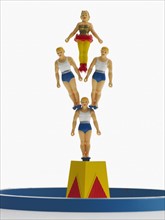 Studio shot of figurines of acrobats. Photo : David Arky