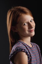 Portrait of redhead girl (10-11), studio shot. Photo : FBP