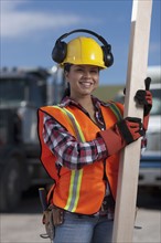 Portrait of female construction worker on building site. Photo : Dan Bannister