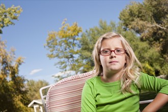Outdoor portrait of blonde USA, Utah, girl (8-9) in glasses. Photo : Tim Pannell