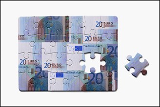 Jigsaw Puzzle with euro notes. Photo : Mike Kemp