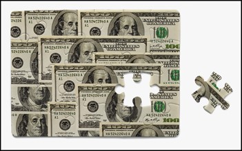 Puzzle with one hundred dollar bills. Photo : Mike Kemp