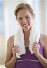 USA, New Jersey, Jersey City, Portrait of woman with towel at gym.