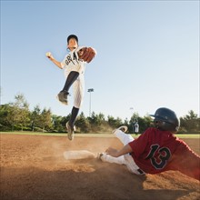 Boys (10-11) playing baseball.