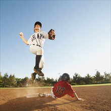 Boys (10-11) playing baseball.