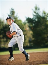 Boy (10-11) playing baseball.