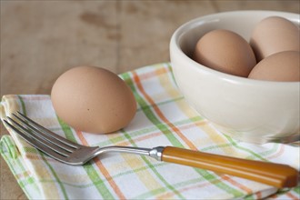 Bowl of boiled eggs with fork.