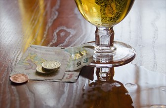 British currency and beer on table.