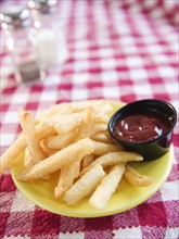 Close up of french fries on checked table cloth. Photo : Jamie Grill Photography