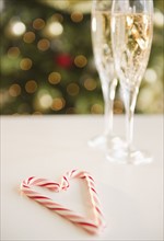 Christmas heart shaped candy canes near champagne. Photo : Jamie Grill Photography