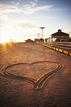 USA, New York City, Coney Island, heart shape in sand. Photo : Shawn O'Connor