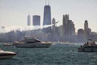 USA, Illinois, Chicago, motor boats and airplane with cityscape at background. Photo : Henryk