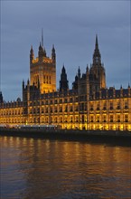 United Kingdom, London, Houses of Parliament illuminated at dusk.