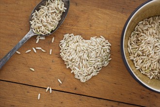 Heart shaped rice with spoon and bowl.