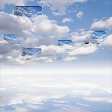 Digital composite with cloudscape and monitors.