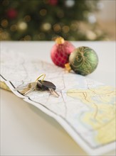 Car keys and baubles on map. Photo : Jamie Grill Photography