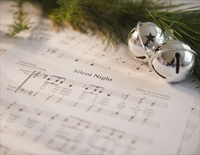 Christmas baubles on carol music sheet . Photo : Jamie Grill Photography