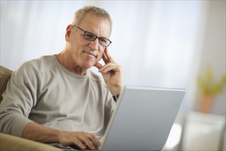 Mature man working on laptop.