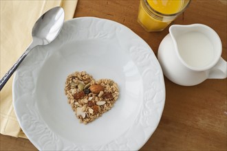 Heart shaped breakfast cereal in bowl.
