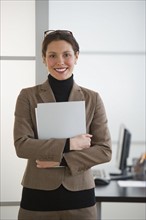 Portrait of young woman in office.